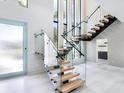 Modern floating staircase with glass railings at 1607 Flower Dr, Sarasota, FL 34239