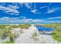 Relaxing beach area with lounge chairs at 709 Bayport Way # 709, Longboat Key, FL 34228