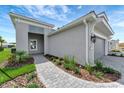 Gray home with a two-car garage and a brick pathway at 2638 Light Sky Ln, Bradenton, FL 34211