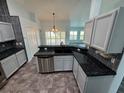 Kitchen with granite countertops, light gray cabinets, and stainless steel appliances at 5009 Sturbridge Ct, Sarasota, FL 34238