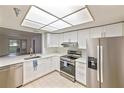 Bright kitchen with stainless steel appliances, white cabinets, and quartz countertops at 6304 Pointe West Blvd # A102, Bradenton, FL 34209