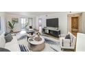 Bright living room featuring modern furniture, stylish rug, and sliding doors to the balcony at 6304 Pointe West Blvd # A102, Bradenton, FL 34209