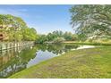 Scenic view of a community pond surrounded by lush greenery and mature trees at 6304 Pointe West Blvd # A102, Bradenton, FL 34209