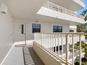 Building exterior showcasing walkway and balcony access at 5780 Midnight Pass Rd # 710, Sarasota, FL 34242