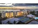Condominium exterior with multiple units, tennis courts, and easy access to parking at 280 Hidden Bay Dr # 302, Osprey, FL 34229