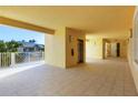 Open-air condo hallway featuring an elevator and balcony views with natural light and tiled floors at 280 Hidden Bay Dr # 302, Osprey, FL 34229