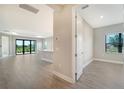 Open concept hallway offering views of the kitchen and living room at 100 Corserra Dr, Nokomis, FL 34275