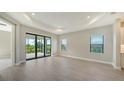 Spacious living area with sliding glass doors leading to a patio at 100 Corserra Dr, Nokomis, FL 34275