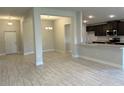 Spacious living area boasting tile floors, recessed lighting, and an open layout connecting to the kitchen at 2600 Averland Loop, North Port, FL 34287