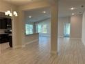 Open-concept living area featuring stylish tile flooring, recessed lighting, and a view into the kitchen at 2600 Averland Loop, North Port, FL 34287