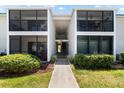 Front view of condo building with walkway and landscaping at 5641 Midnight Pass Rd # 902, Sarasota, FL 34242
