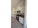 White shaker cabinets, granite countertops, and stainless steel appliances in the kitchen at 2593 Englewood Rd, Venice, FL 34293
