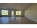 Bright and spacious living area with large windows and tile flooring at 2593 Englewood Rd, Venice, FL 34293