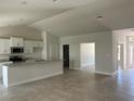 Open-concept living room with tile flooring, seamlessly connected to the kitchen area at 2679 Englewood Rd, Venice, FL 34293
