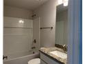 Bathroom with shower/tub combo, granite counters, and updated fixtures at 855 Cumberland Rd, Venice, FL 34293