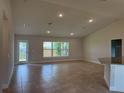 Bright living room features neutral paint, recessed lighting and large windows at 855 Cumberland Rd, Venice, FL 34293
