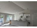 Spacious kitchen with white cabinets and a large island at 2679 Englewood Rd, Venice, FL 34293