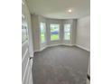 Bright bedroom with bay window and plush carpet, offering a comfortable retreat at 664 Linden Rd, Venice, FL 34293