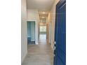 Inviting hallway with tile flooring leading to various rooms, enhancing the home's modern flow at 664 Linden Rd, Venice, FL 34293