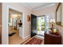 Bright and airy entryway with a view into the kitchen and access to the outdoors at 915 Barclay Ct, Venice, FL 34293