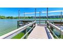 Wooden community dock with benches overlooking a calm lake at 3839 Lake Bayshore Dr # H516, Bradenton, FL 34205