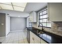 Modern kitchen with a large sink and white cabinets at 7802 Scruboak Ct, Hudson, FL 34667