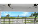 Balcony with water view and ceiling fans at 1425 Park Beach Cir # 122, Punta Gorda, FL 33950