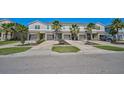 Row of townhomes with attached garages and landscaping at 4737 Vignette Way, Sarasota, FL 34240