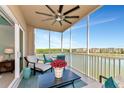 Relaxing screened balcony with ceiling fan, seating and beautiful lake view at 10520 Boardwalk Loop # 401, Lakewood Ranch, FL 34202