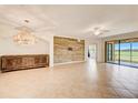 Spacious living room featuring tile floors and a large wood wall at 7008 Grand Estuary Trl # 104, Bradenton, FL 34212