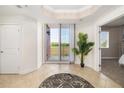 Bright foyer featuring tile floors, balcony access, and views to the exterior at 611 Riviera Dunes Way # 108, Palmetto, FL 34221