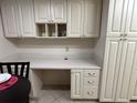 White kitchen cabinets and a built-in desk at 6503 Stone River Rd # 109, Bradenton, FL 34203