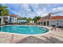 Community pool with plenty of lounge chairs and a covered seating area at 210 3Rd W St # 8407, Bradenton, FL 34205