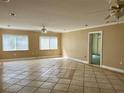 Bright living room featuring neutral colors, large windows, and tile flooring at 6613 Blue Heron S Dr, St Petersburg, FL 33707