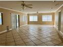 Open-concept living area with tile flooring, ceiling fan, and sliding glass door at 6613 Blue Heron S Dr, St Petersburg, FL 33707