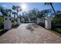 Elegant brick driveway leading to a stunning beach house at 7730 Manasota Key Rd, Englewood, FL 34223