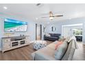 Cozy living room with a large TV, comfortable sofas, and ample natural light from the windows at 5900 Driftwood Ave, Sarasota, FL 34231