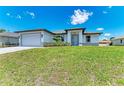 Single-story home with a gray garage door and driveway at 8380 Malcolm Ave, North Port, FL 34287