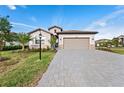 Charming single-Gathering home with a well-manicured lawn, beautiful landscaping, and a paved driveway leading to a two-car garage at 15739 Barefoot Beach Dr, Bradenton, FL 34211