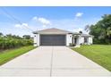 Attractive single-story home featuring a well-maintained lawn, a spacious driveway, and a convenient two-car garage at 2511 Stagnaro Rd, North Port, FL 34287