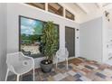 Inviting front porch with modern chairs and a potted plant at 2832 Greenbriar St, Sarasota, FL 34237