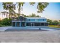 Two-story home with a screened porch and expansive backyard at 655 N Clermont Rd, Venice, FL 34292