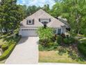 Beautiful single-story home with lush landscaping and a brick-paved driveway at 7249 Orchid Island Pl, Bradenton, FL 34202