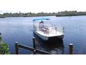 A stunning waterfront view showcasing a large pontoon boat on a sunny day at 1415 Piedmont Rd, Venice, FL 34293