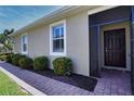 Exterior view of the home's entrance with a nicely landscaped walkway at 13458 Abercrombie Dr, Englewood, FL 34223