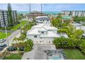 Aerial view of this house showcasing its rooftop deck, and proximity to the beach, ocean, and cityscape at 149 Mckinley Dr, Sarasota, FL 34236