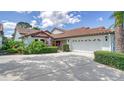 Villa with a tile roof, two-car garage, and well-maintained landscaping at 4440 Calle Serena, Sarasota, FL 34238