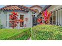 Front entrance with lush tropical plants and decorative gate at 4440 Calle Serena, Sarasota, FL 34238