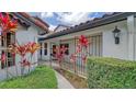 Side entrance with walkway, wrought iron gate and tropical plants at 4440 Calle Serena, Sarasota, FL 34238