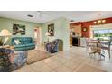 Open living space with teal couch, dining area, and kitchen views at 1255 Lincoln Dr, Englewood, FL 34224